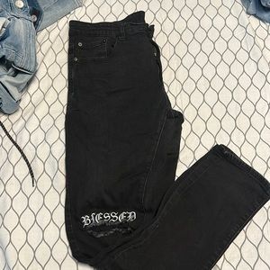 Simple black jeans with rip in knees and words say blessed